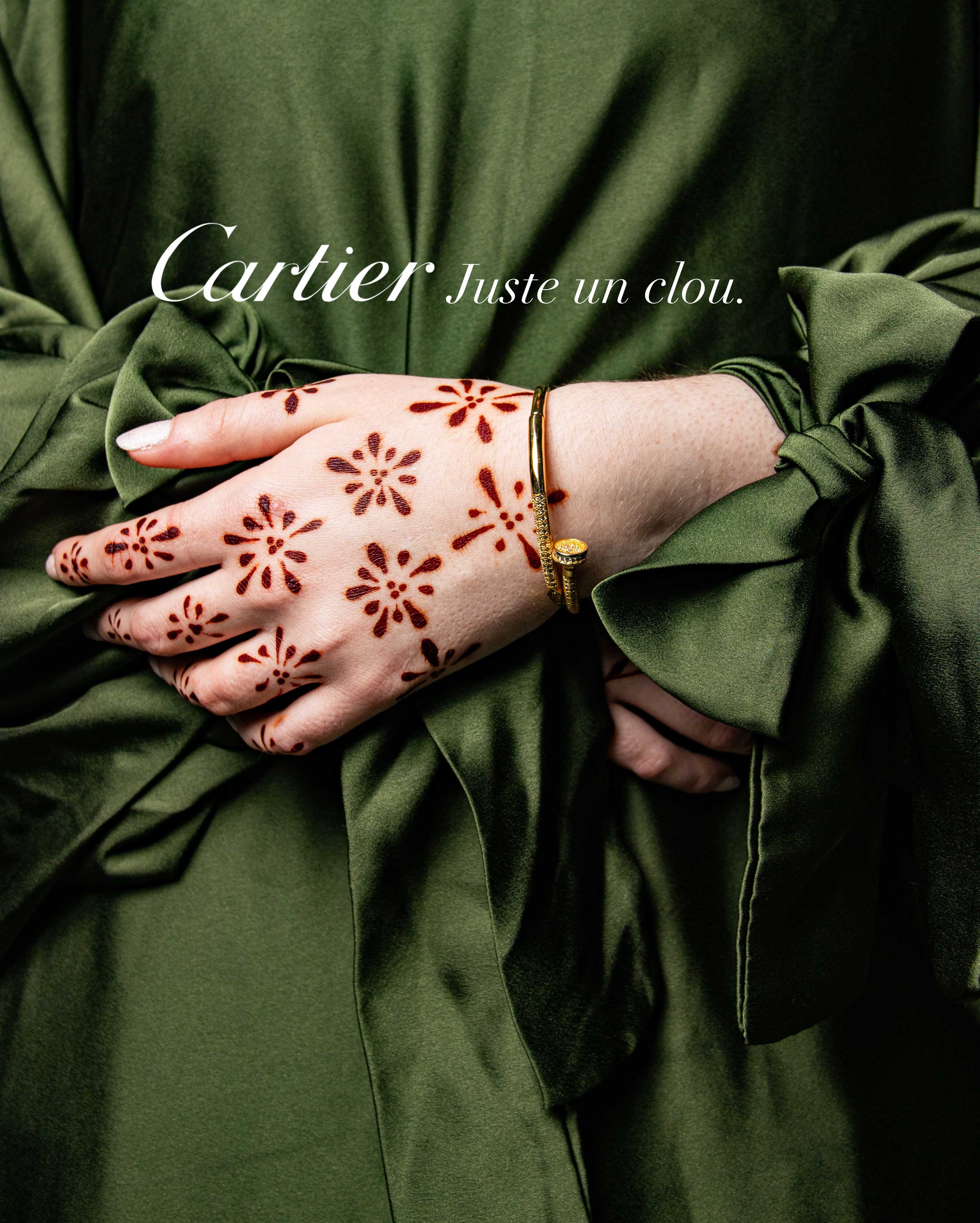 a photo of a close up with hands wearing henna and a gold bracelet