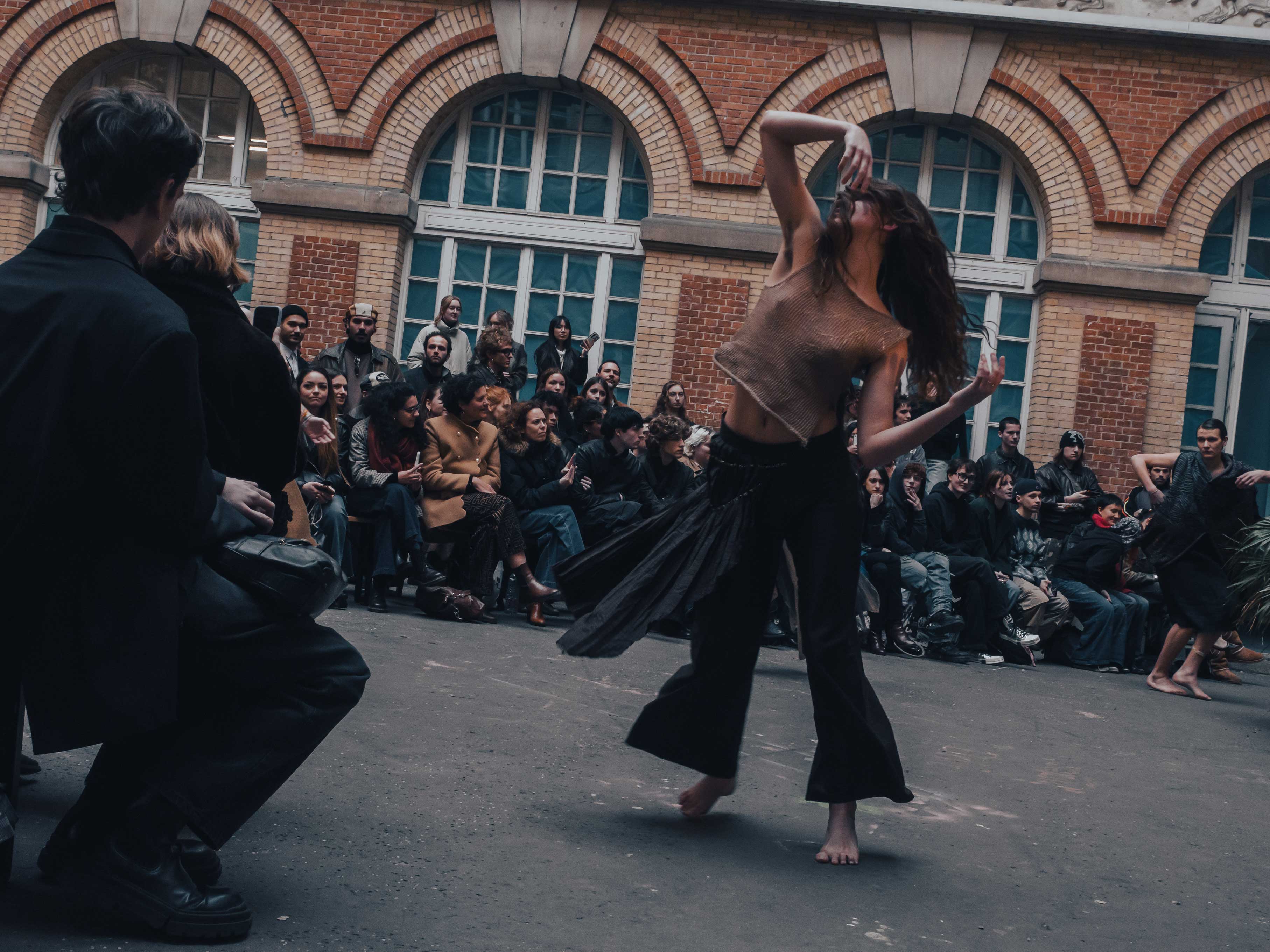 photo of a runway and the model is dancing