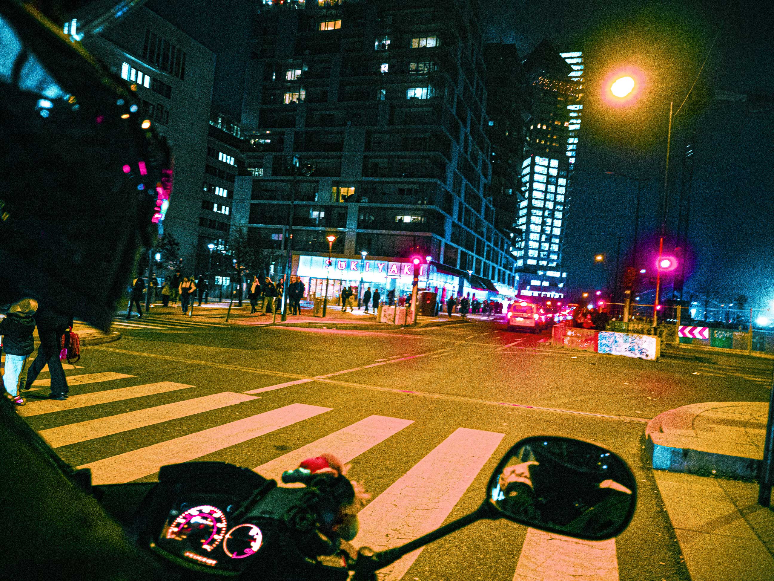 a photo of Paris BNF at night. lights are yellow, blue and red.