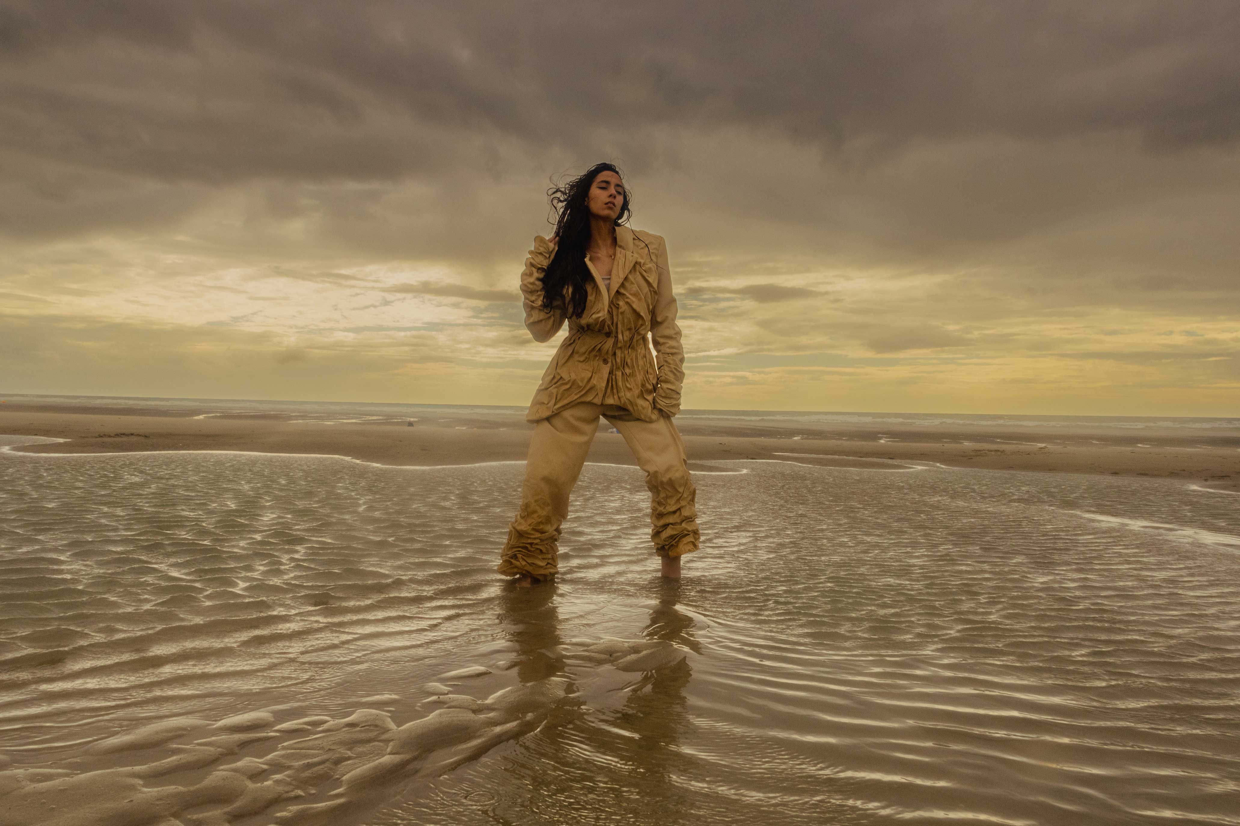 photo of a woman posing with a sunset behind