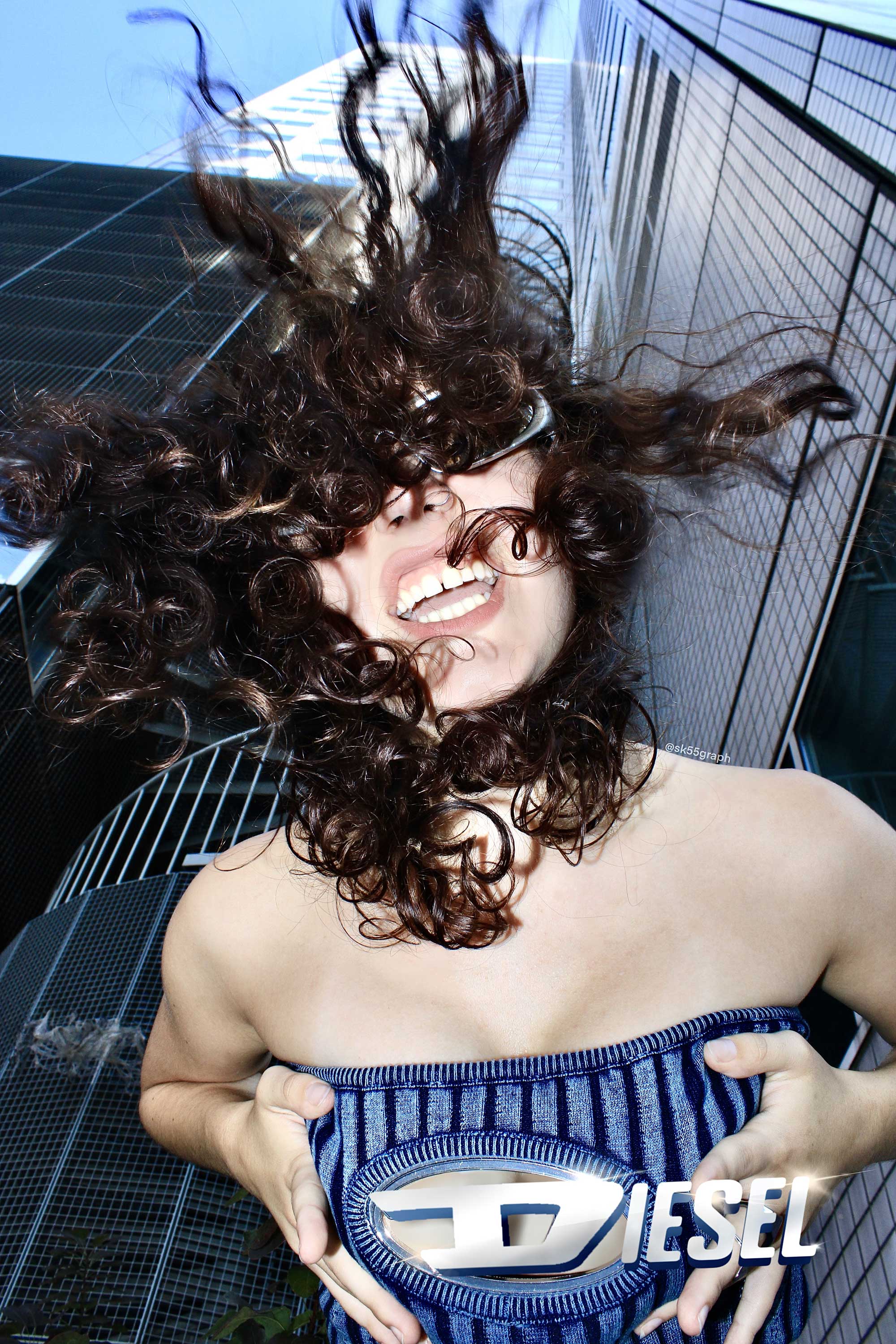 a photo of a woman screaming with her hair in the front and skyscrapers in the background, its a fake ad for diesel