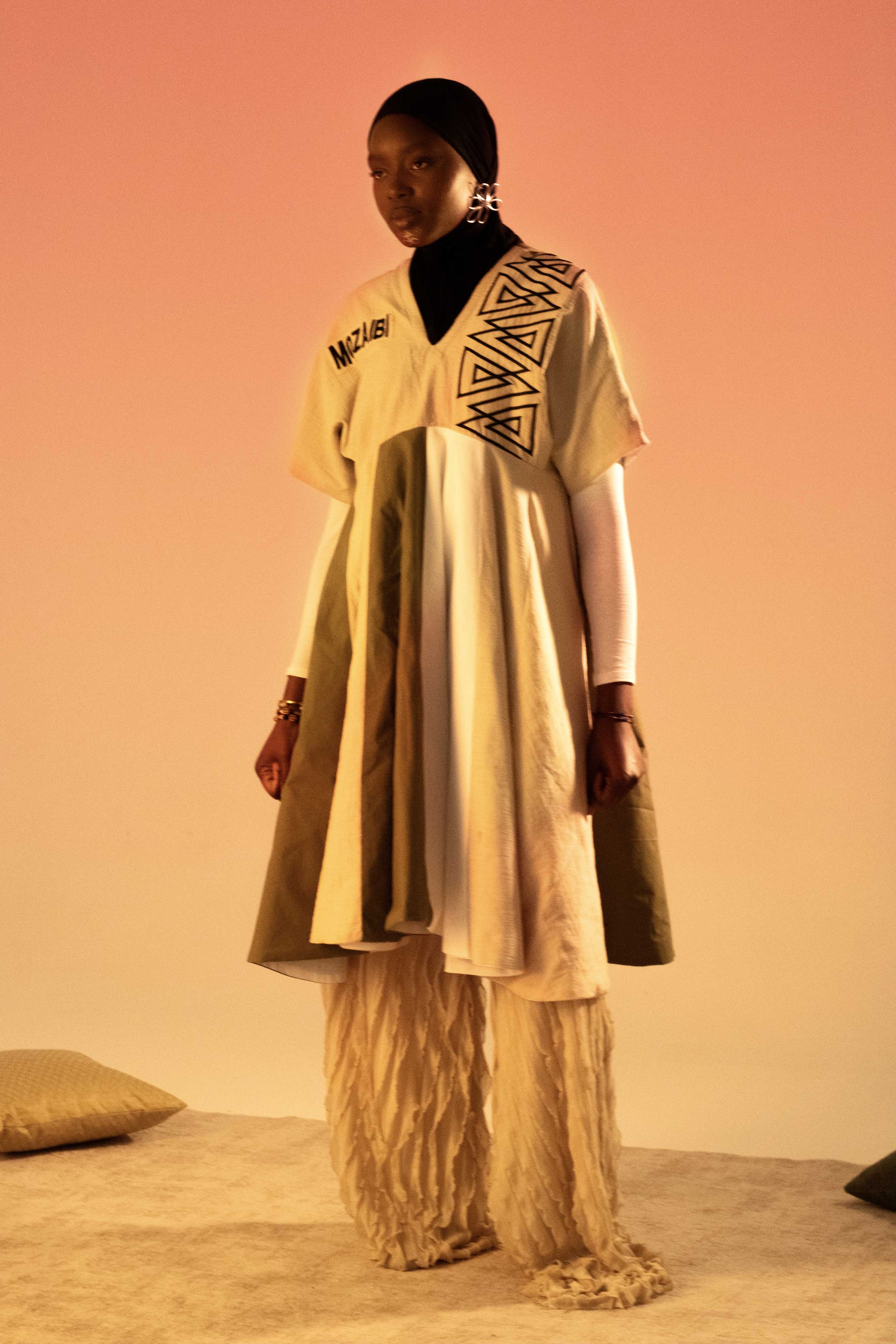 photo of a woman wearing a morrocan-inspired outfit with a gradient orange background imitating a sunset